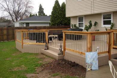 Deck - mid-sized backyard deck idea in Milwaukee with no cover