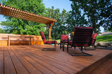 Large backyard deck photo in DC Metro with a pergola