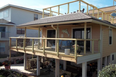 Deck - mid-sized traditional side yard deck idea in Jacksonville with a roof extension