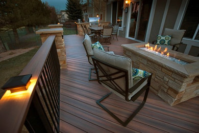 Photo of a traditional back terrace in Denver with a fire feature.