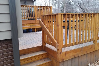 Example of a mid-sized arts and crafts backyard deck design in Other with no cover