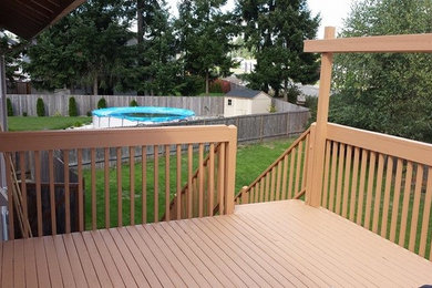 Deck - mid-sized side yard deck idea in Seattle with a roof extension