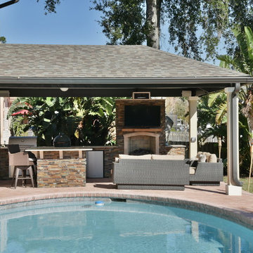 Outdoor kitchen with Blaze gas grill, Big Green Egg and fireplace.