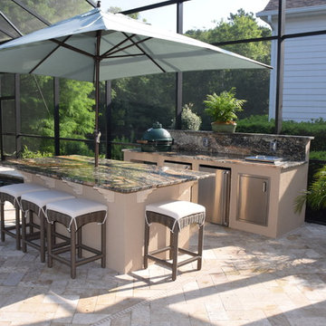 Outdoor Kitchen with large island, two refrigerators and Big Green Egg