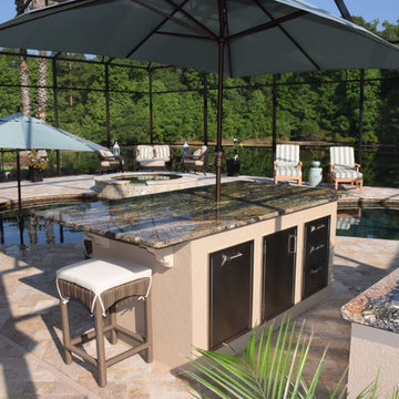 Outdoor Kitchen with large island, two refrigerators and Big Green Egg