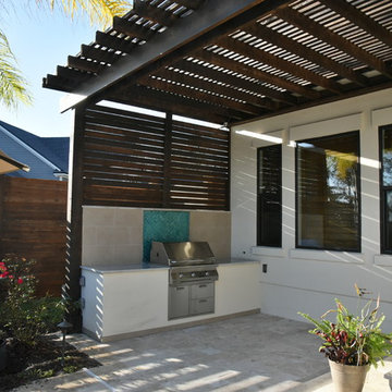 Outdoor kitchen with pergola and privacy wall