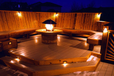 Mid-sized backyard deck photo in Denver with a fire pit and no cover