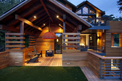Example of a mid-sized minimalist backyard deck design in San Francisco with a roof extension