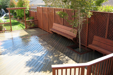 Mid-sized elegant backyard deck photo in Other with a pergola