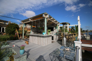 This is an example of a medium sized mediterranean back terrace in San Francisco with an outdoor kitchen and a roof extension.