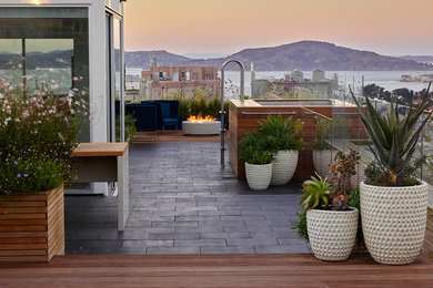 Large trendy rooftop deck photo in San Francisco with a fire pit and no cover