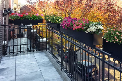 Small elegant backyard deck container garden photo in New York with no cover