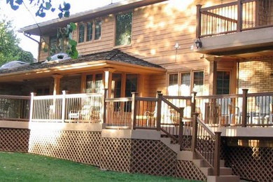 Deck - large transitional backyard deck idea in Denver with a roof extension