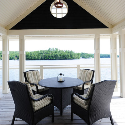 Inspiration for a mid-sized coastal backyard deck remodel in Other with a roof extension