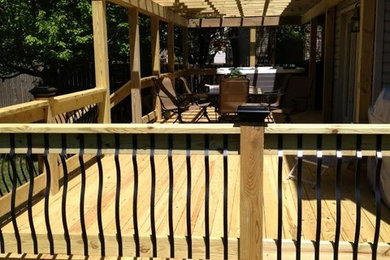 Deck - mid-sized craftsman backyard deck idea in Louisville with a pergola