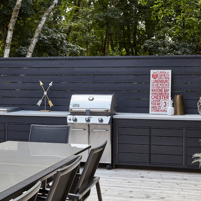Outdoor kitchen deck - large modern backyard outdoor kitchen deck idea in Toronto with a pergola