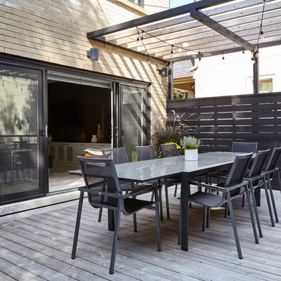 Inspiration for a large modern backyard outdoor kitchen deck remodel in Toronto with a pergola