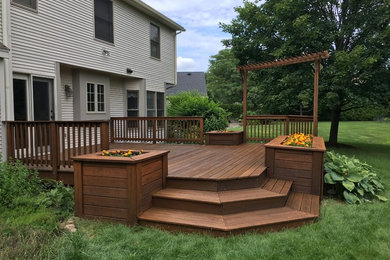 Inspiration for a mid-sized transitional backyard deck container garden remodel in New York with no cover