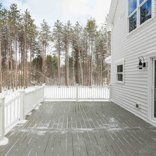 Example of a large farmhouse backyard deck design in Portland Maine with no cover