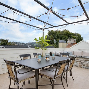 Mid-sized elegant rooftop rooftop deck photo in Orange County with a fire pit and a pergola