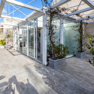 This is an example of a large contemporary rooftop and rooftop deck in Catania-Palermo with a pergola.