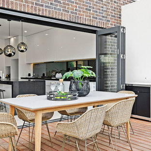 Photo of a transitional backyard deck in Melbourne with an outdoor kitchen and no cover.