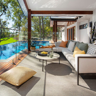 Inspiration for a beach style ground level deck in Brisbane with glass railing.