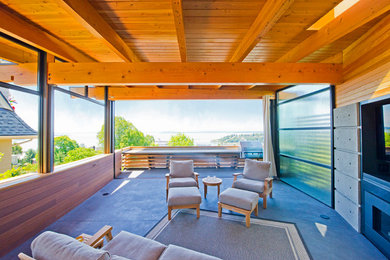 Deck - modern backyard deck idea in Seattle with a roof extension