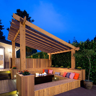 Inspiration for a transitional deck remodel in Vancouver with a fire pit and a pergola
