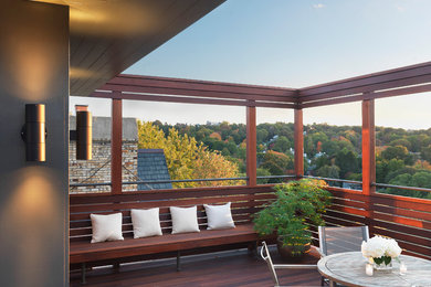 Inspiration for a mid-sized contemporary deck remodel in Boston with a roof extension