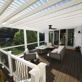 Large arts and crafts backyard deck photo in St Louis with a fireplace and an awning