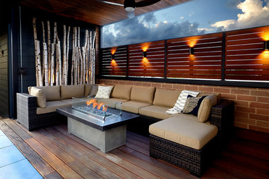 Inspiration for a large contemporary rooftop deck remodel in Chicago with a fire pit and a roof extension