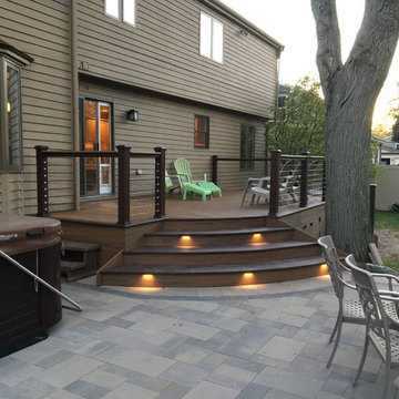 Rose Outdoor Living Space Curving Trex Deck with Stainless Steel Cable Rail