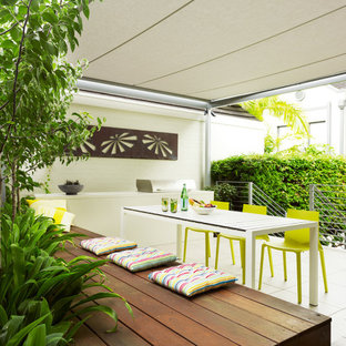 Design ideas for a mid-sized contemporary backyard deck in Sydney with an awning.
