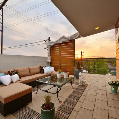 Inspiration for a contemporary deck container garden remodel in Austin with a roof extension
