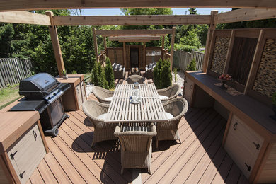 Inspiration for a mid-sized timeless backyard outdoor kitchen deck remodel in Toronto with a pergola