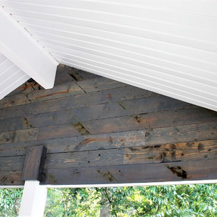 Example of a mid-sized country backyard deck design in Other with a roof extension
