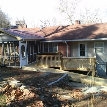 screened in porch with metal roof, deck and handicap ramp