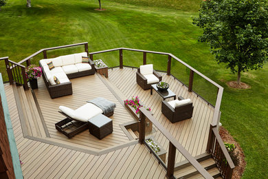 Huge elegant backyard deck photo in Other