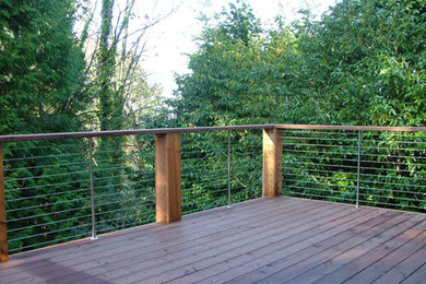 Example of a mid-sized minimalist deck design in Seattle with no cover