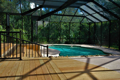 Example of a huge island style backyard deck design in Orlando