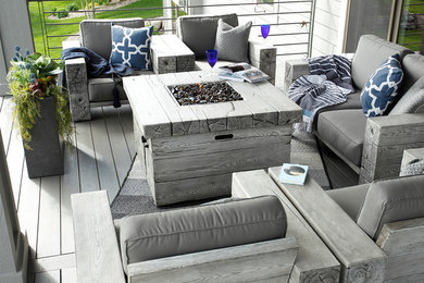 Example of a mid-sized trendy backyard deck design in Other with a fire pit and a roof extension