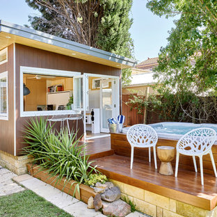 This is an example of a small contemporary side yard deck in Sydney with a container garden and no cover.