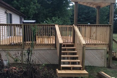 This is an example of a medium sized back terrace in Cincinnati with a pergola.