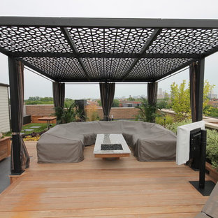 Esempio di una grande terrazza design sul tetto con una pergola