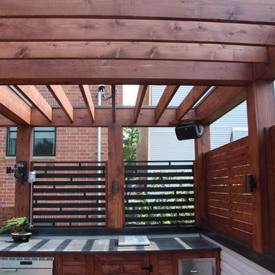 Example of a mid-sized minimalist rooftop outdoor kitchen deck design in Chicago with a pergola