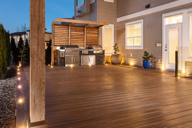 Outdoor kitchen deck - large modern backyard outdoor kitchen deck idea in Vancouver with no cover