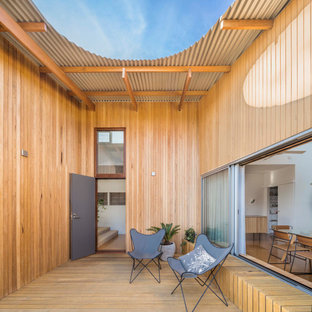 This is an example of a beach style courtyard deck in Adelaide with no cover.