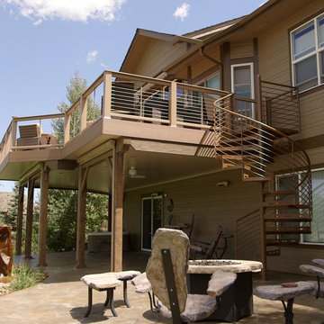 Spiral stairs lead from deck above to patio below