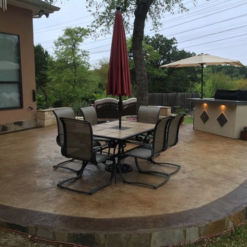 Stamped and Stained Decorative Concrete Patio with Limestone Retaining Wall